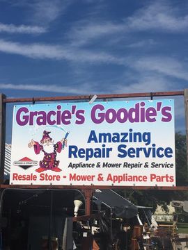 Sign for Gracie's Goodie's, a repair and resale store, with a wizard graphic.