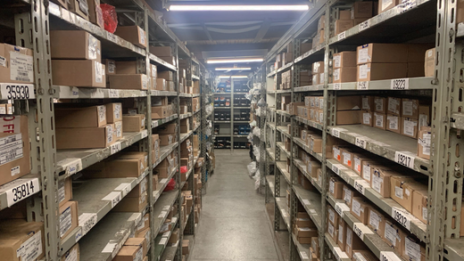 Warehouse storage shelves filled with cardboard boxes.