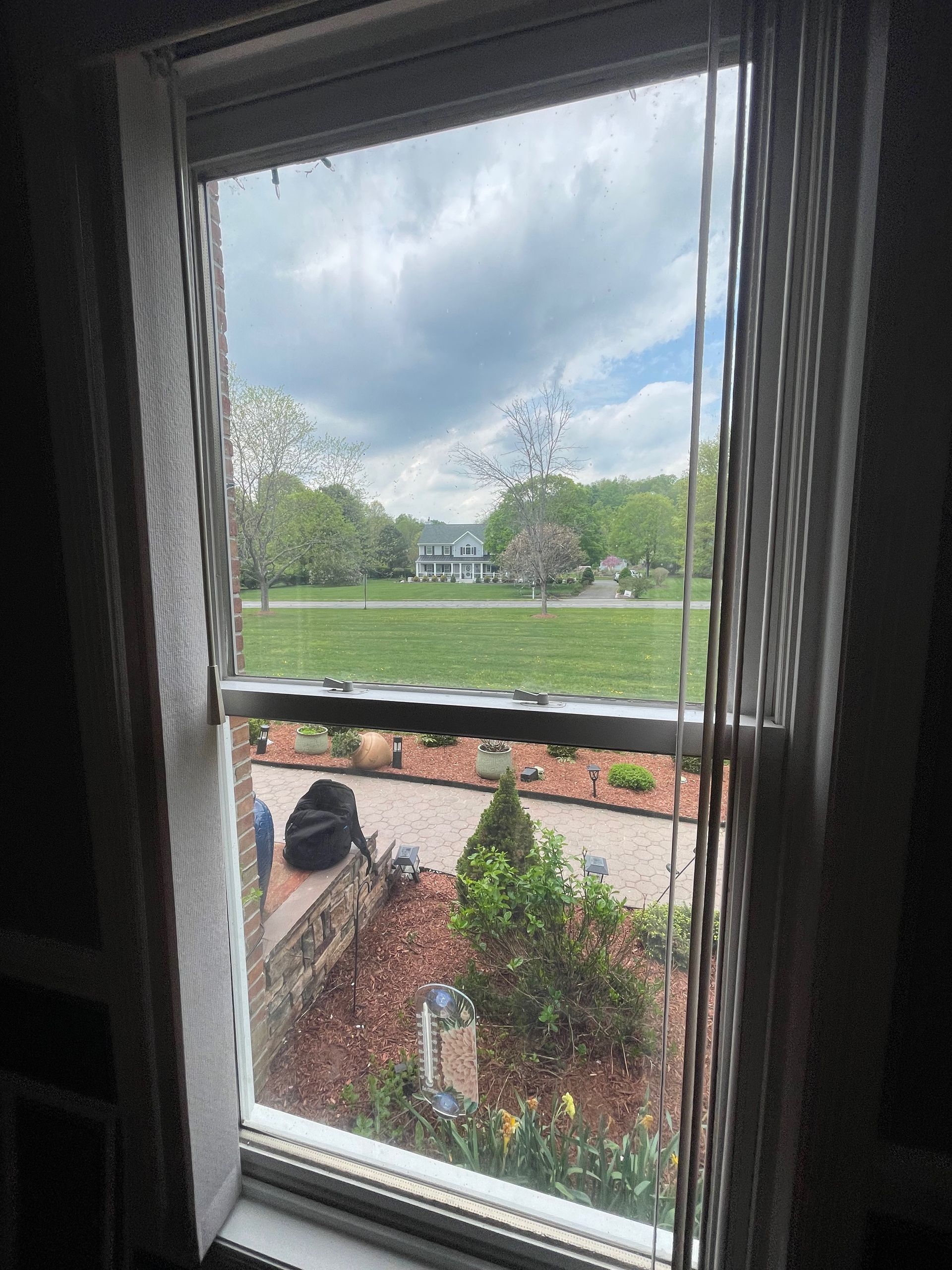 A window with a view of a lush green field