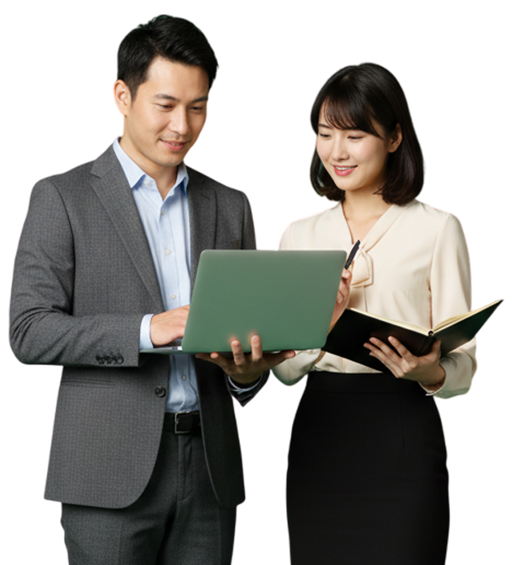 Man and woman looking at laptop, both smiling. Woman holds notebook, both in business attire.
