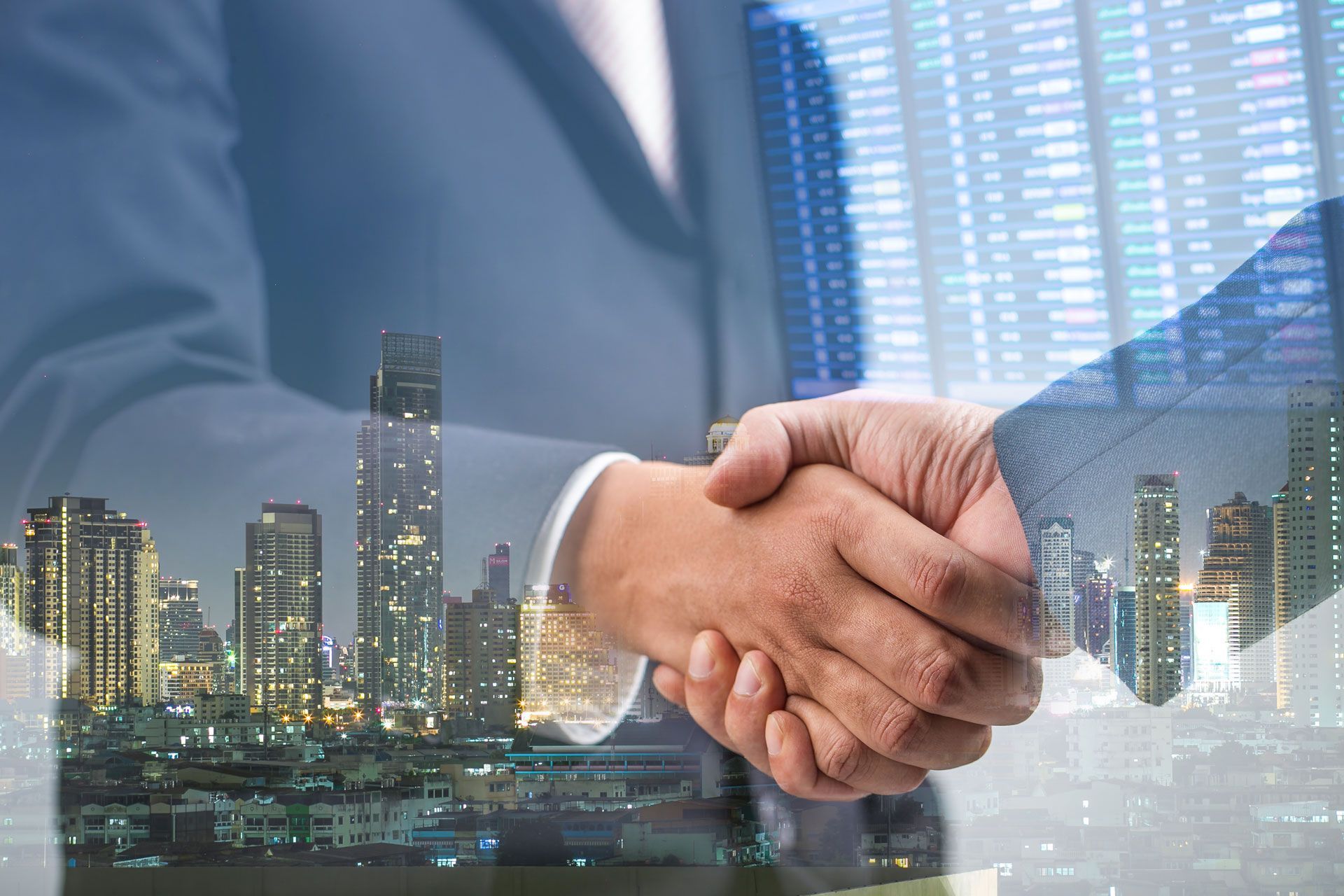 Business people shaking hands, city backdrop, symbolizing agreement or partnership.