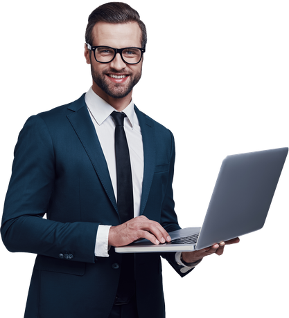 Man in a dark suit, glasses, and tie, smiling while holding a laptop.