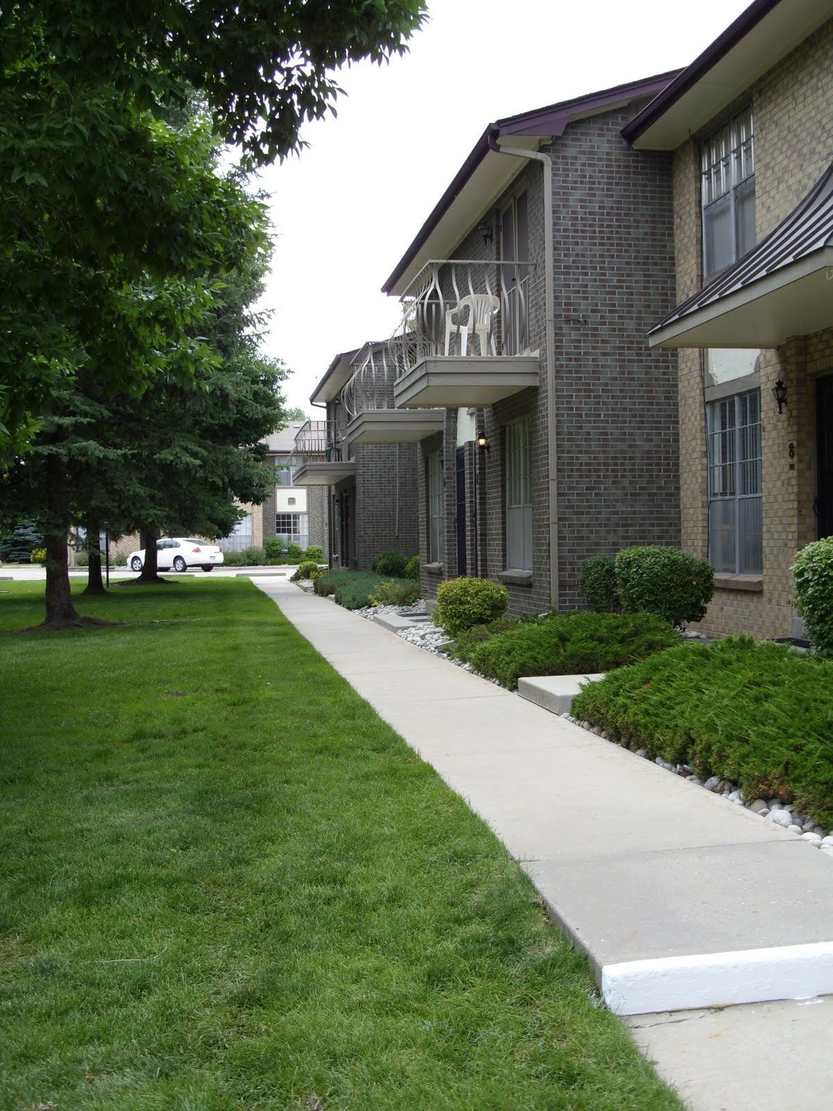 A row of apartment buildings with a walkway between them