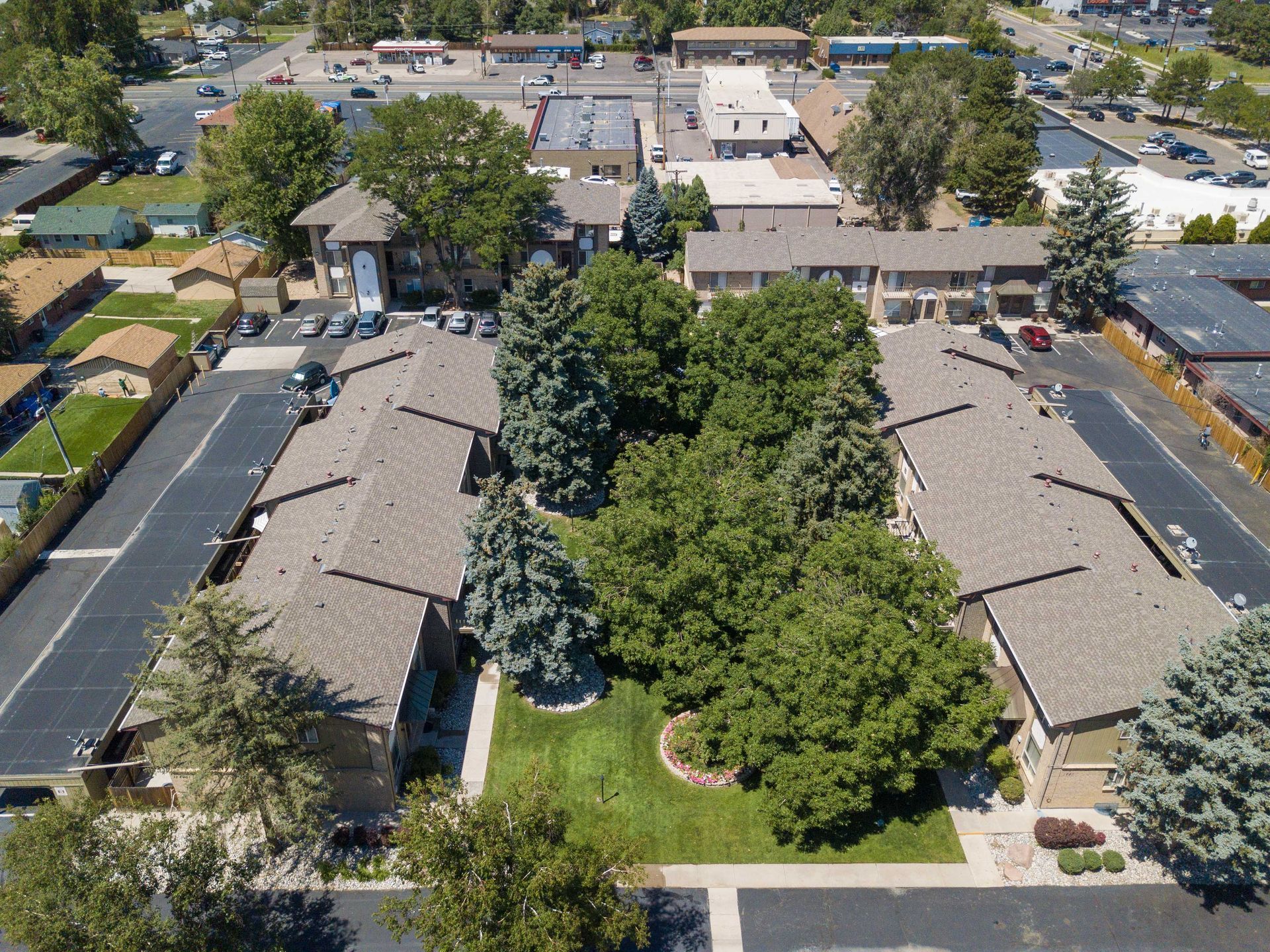 An aerial view of a residential area with lots of trees and buildings.