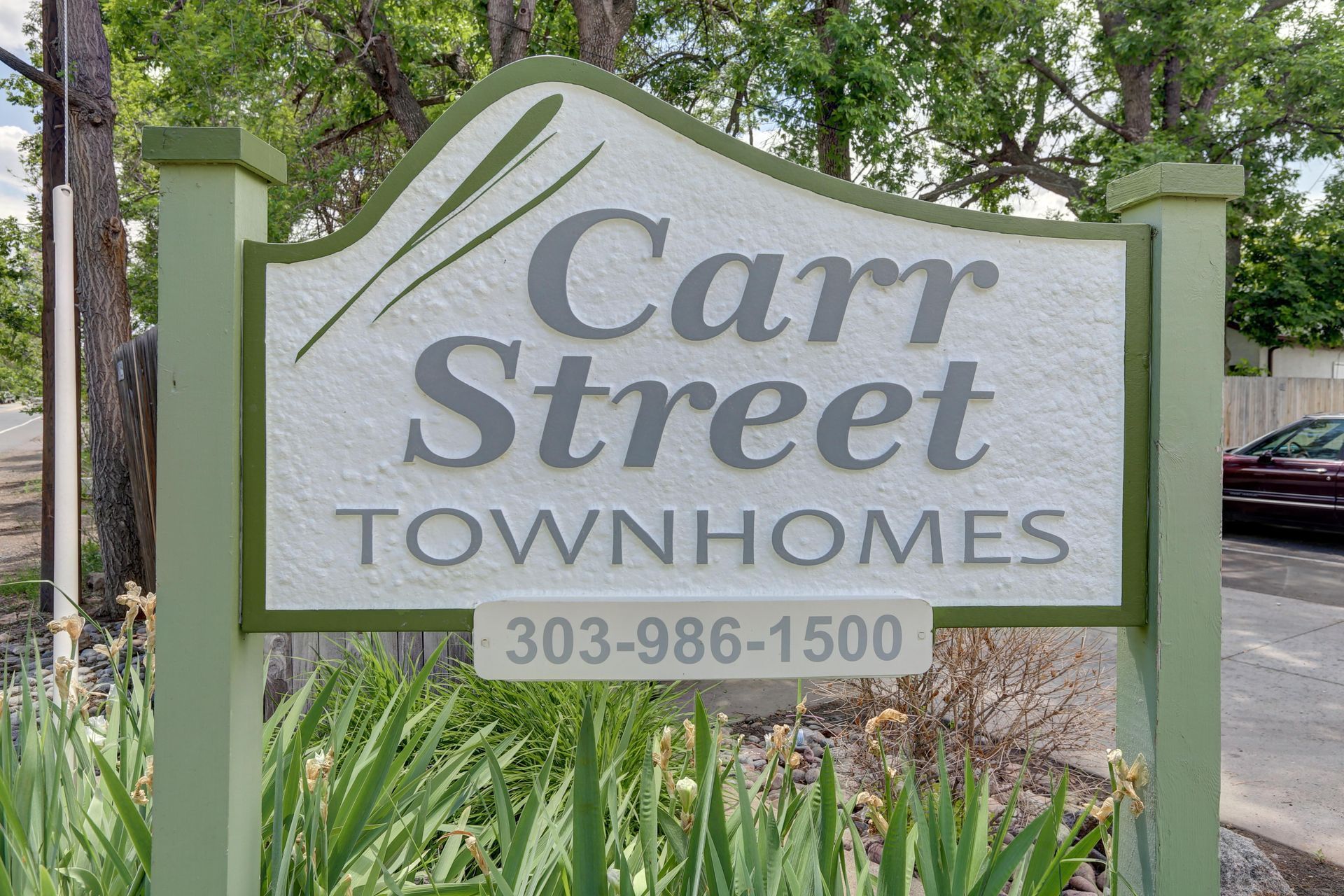 A sign for carr street townhomes with a phone number