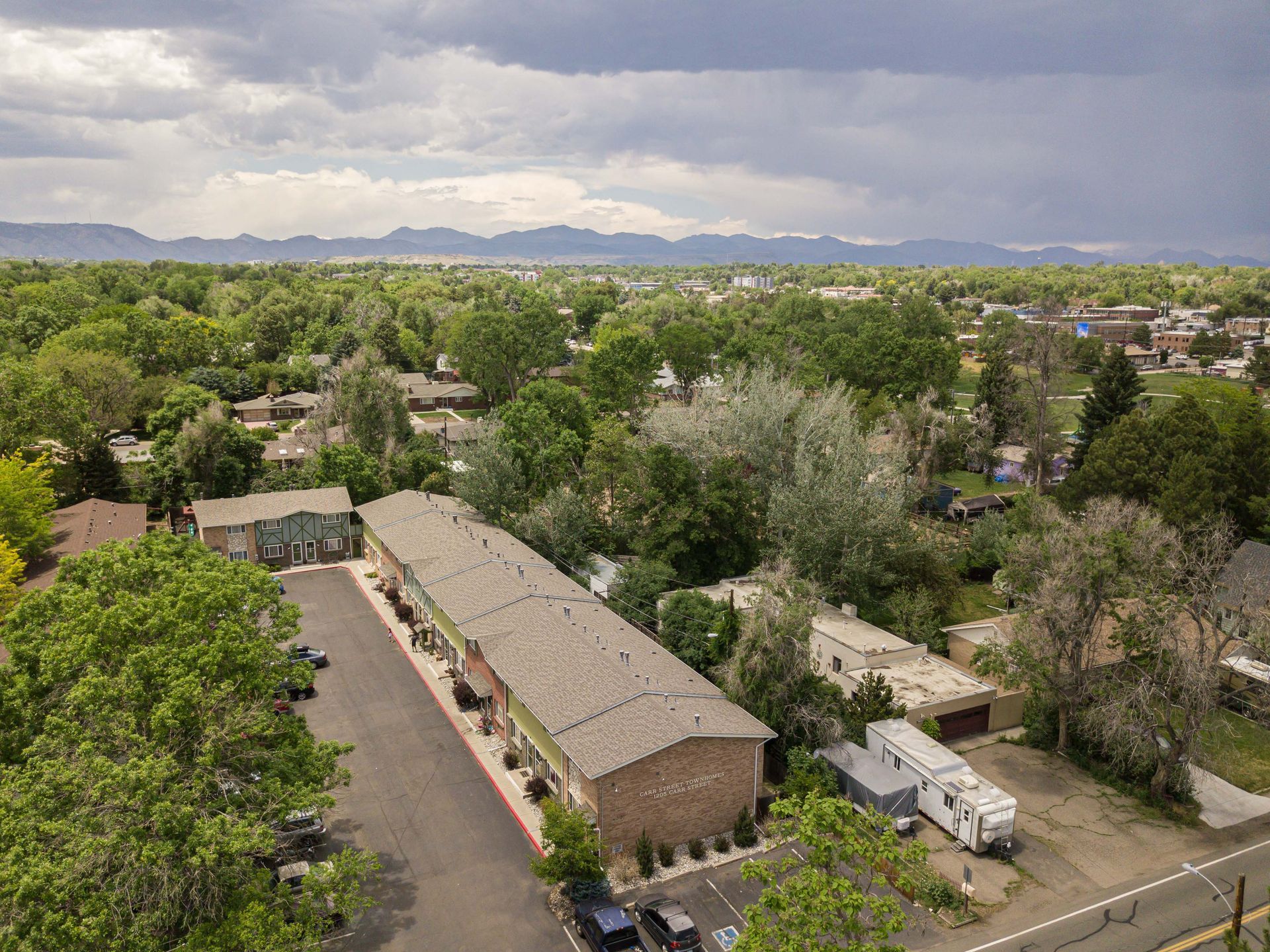 An aerial view of a small town with mountains in the background.