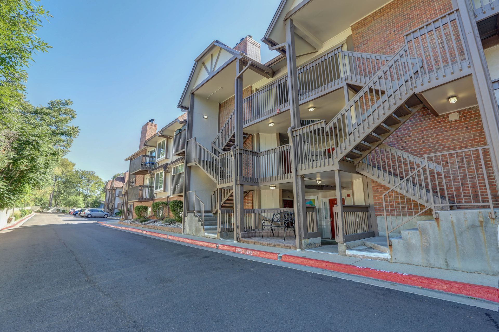 A large apartment building with stairs leading up to the second floor.