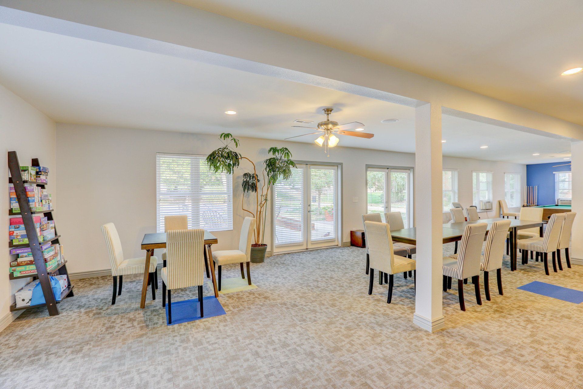 A large room with tables and chairs in it.