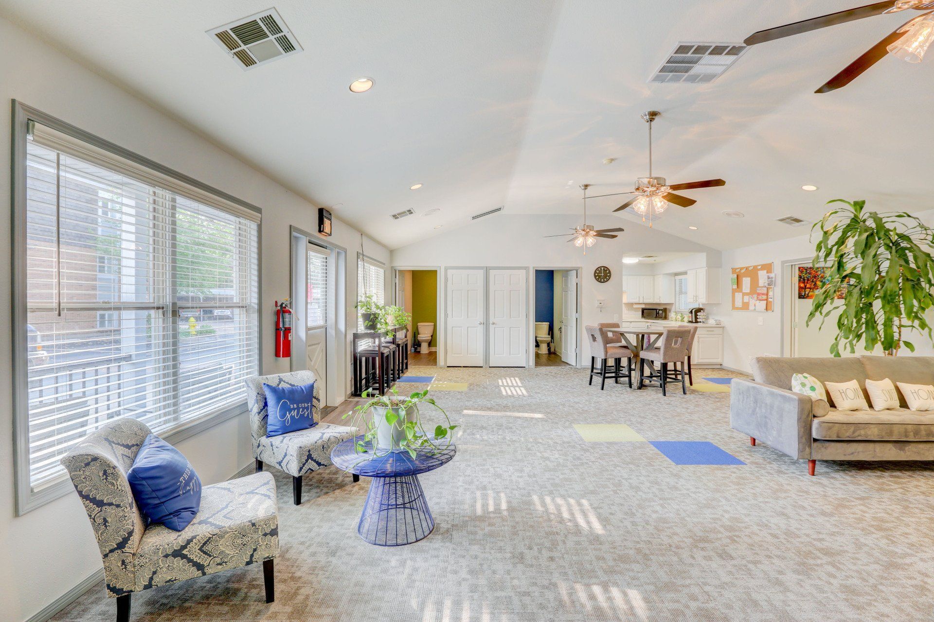 A living room filled with furniture and a ceiling fan.