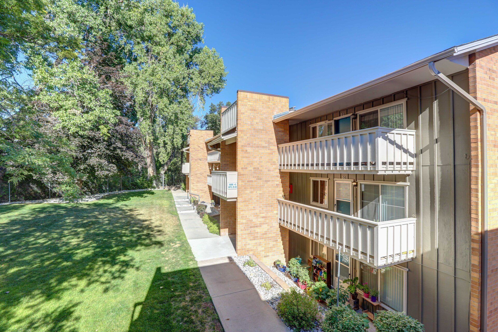 A large apartment building with a lot of windows and balconies.