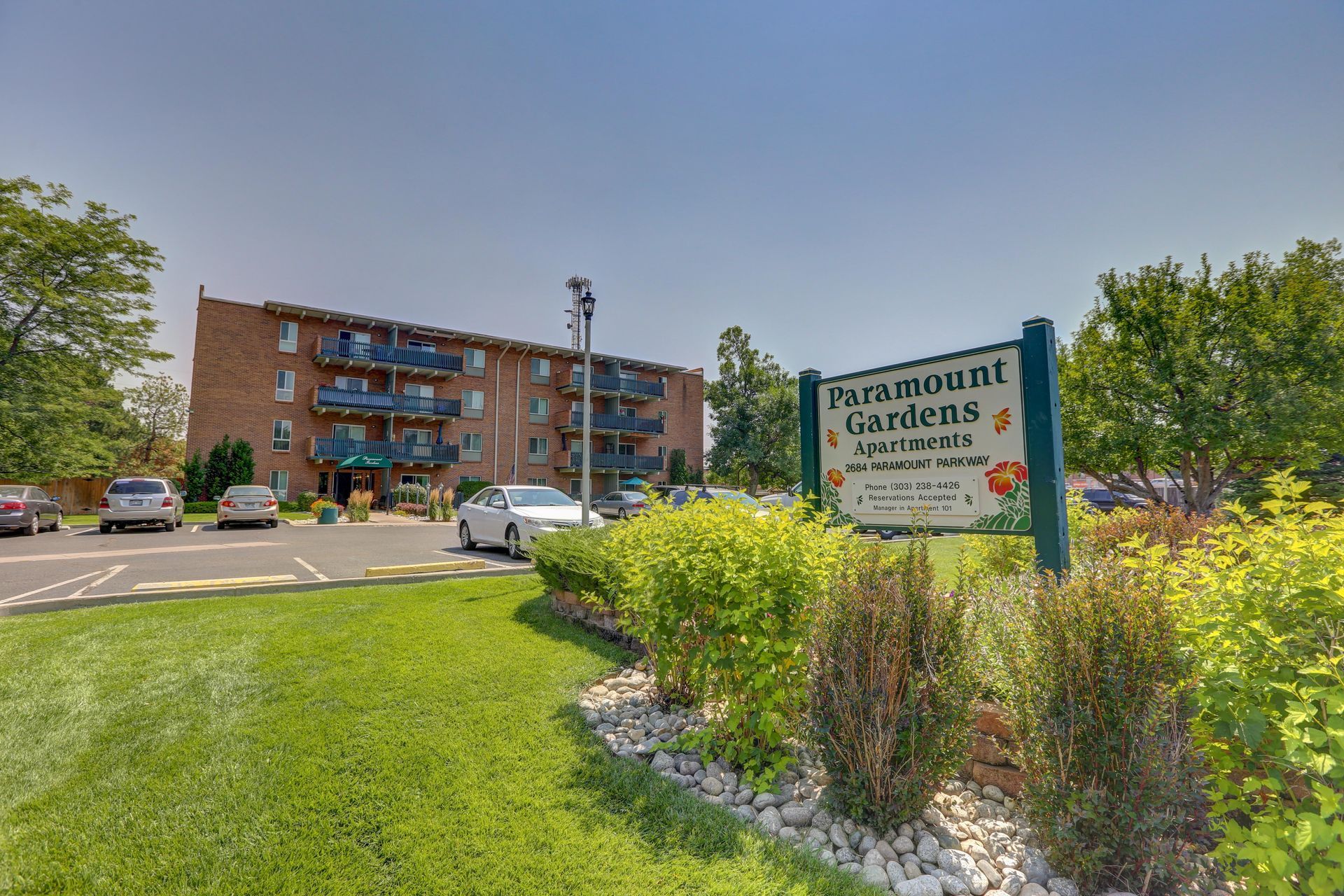 A sign for parkmount gardens is in front of a building.