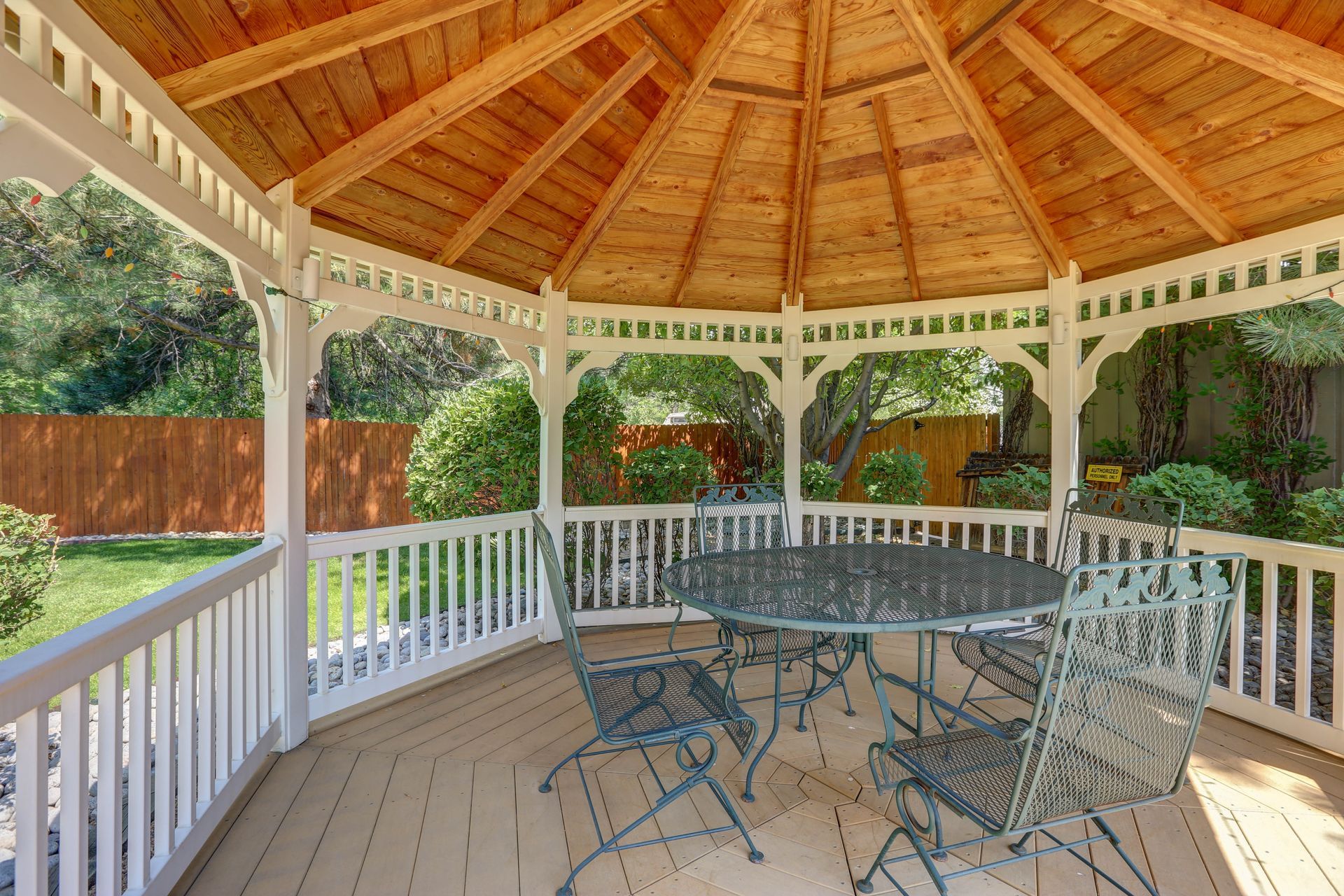 A gazebo with a table and chairs inside of it.