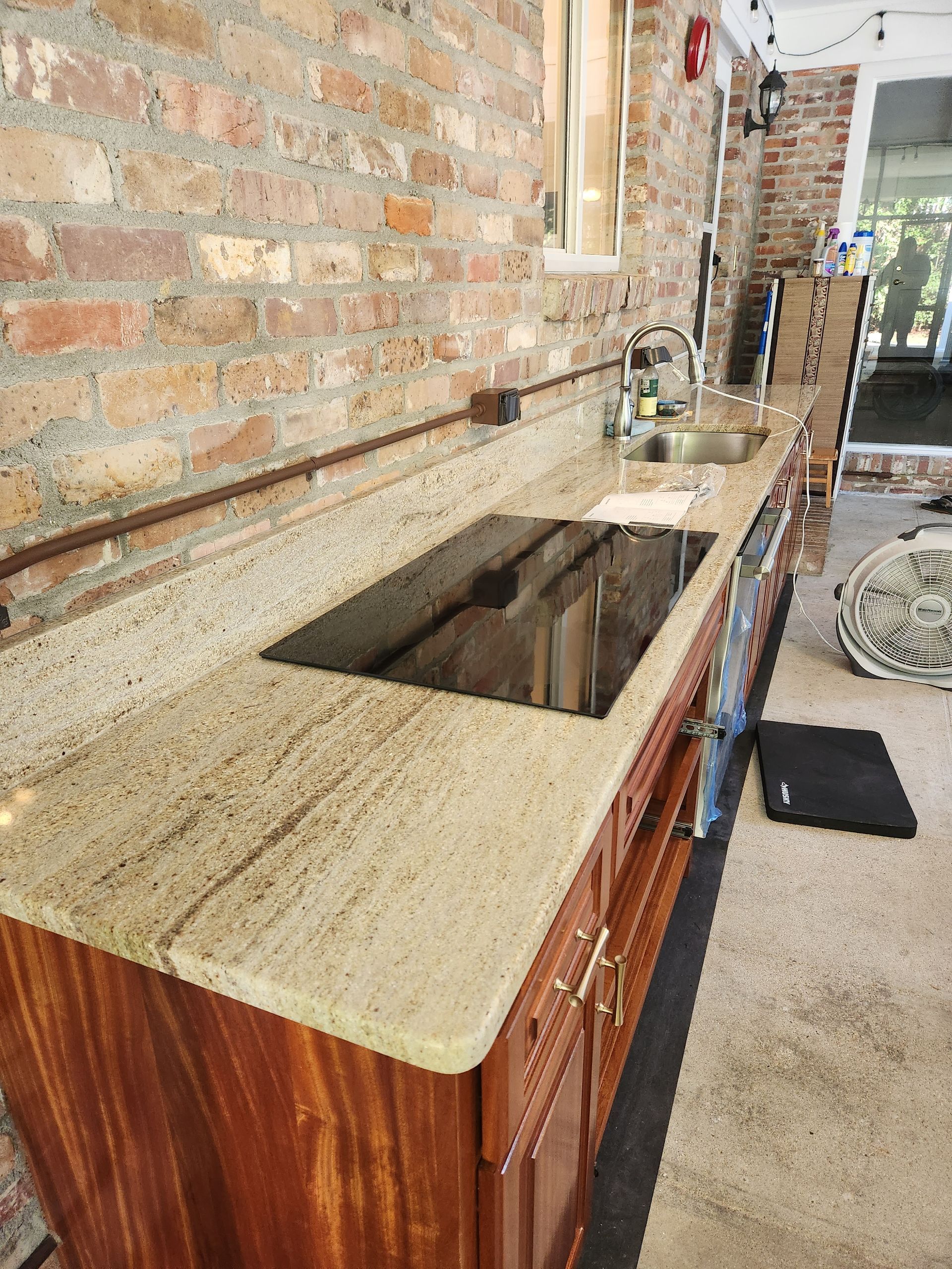 A kitchen with a stove top oven and a sink.