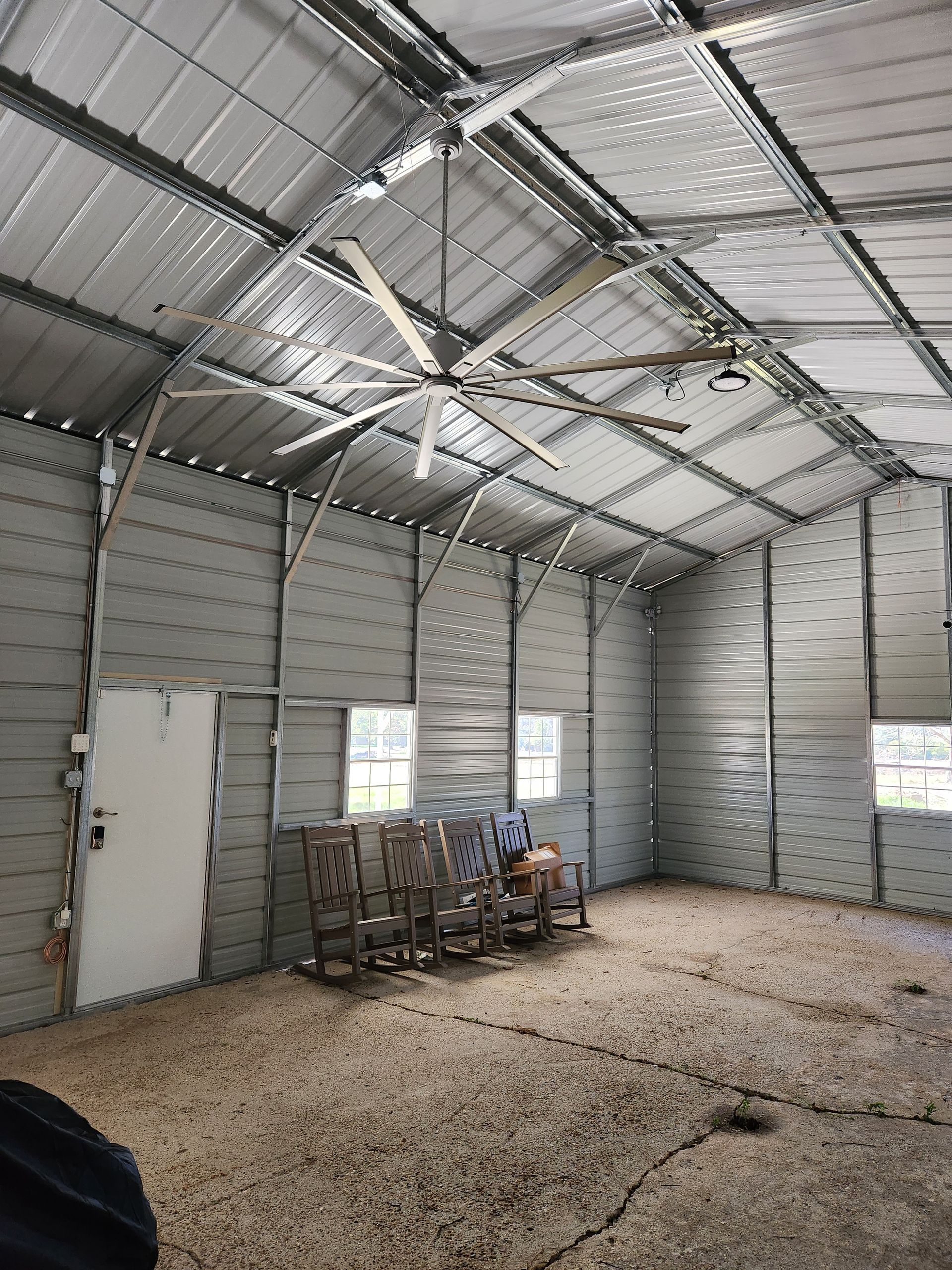 There is a ceiling fan in the middle of the room.