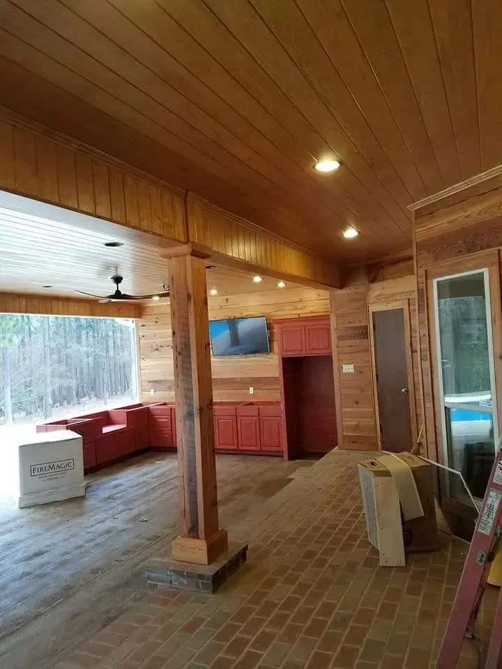 A large room with a wooden ceiling and a brick floor.