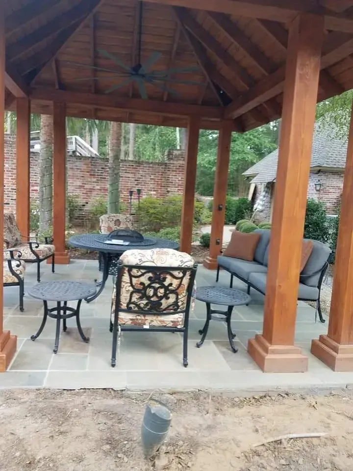 A gazebo with a table and chairs underneath it