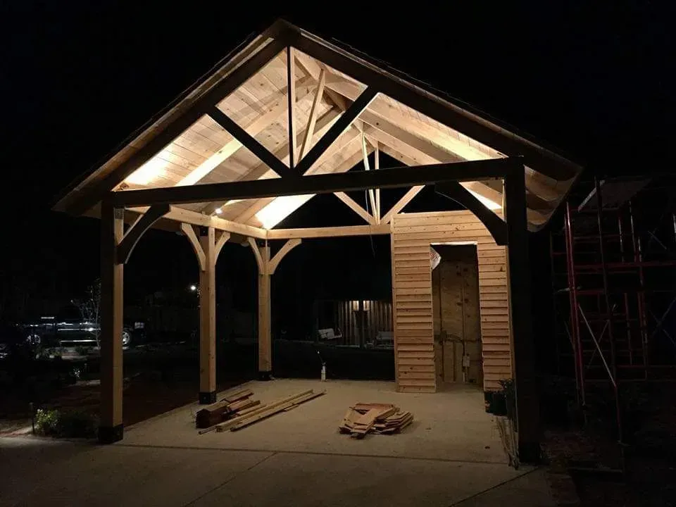 A wooden structure is lit up at night.