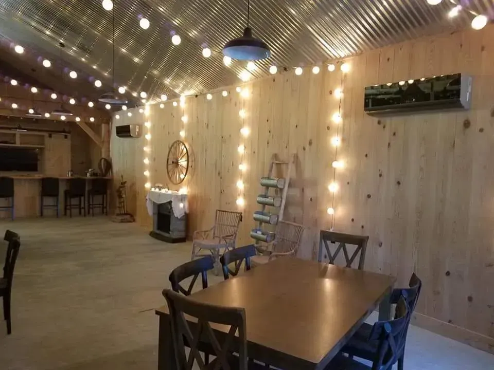 There is a table and chairs in the middle of the room.