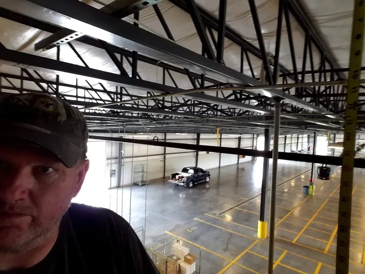 Bryan Lee standing in an empty warehouse