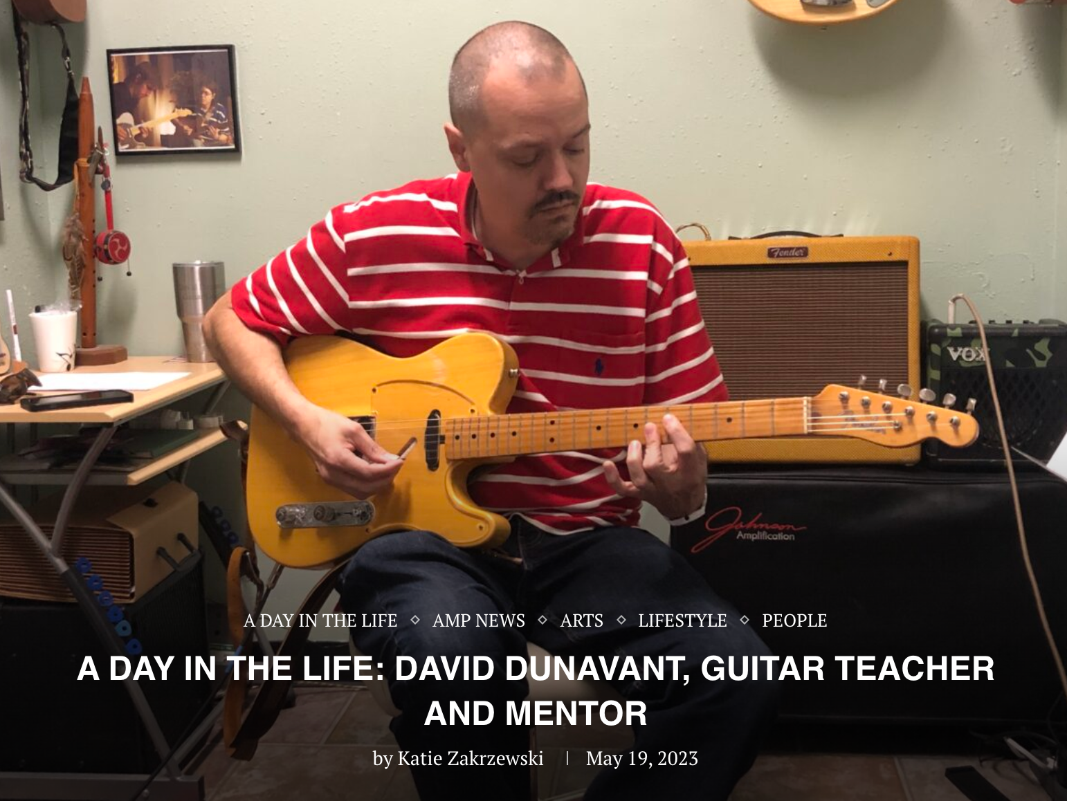 David Dunavant is teaching guitar lessons in a room with many guitars on the wall, located in little rock Arkansas.