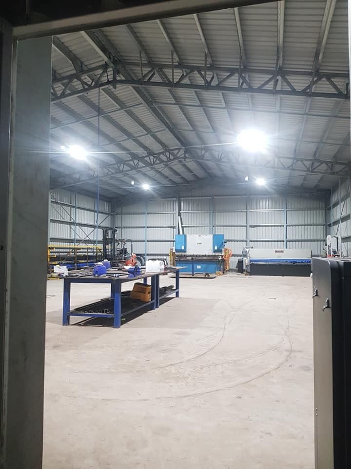 A Large Warehouse With A Lot Of Machinery In It — Prowire Services In Walkerston, QLD