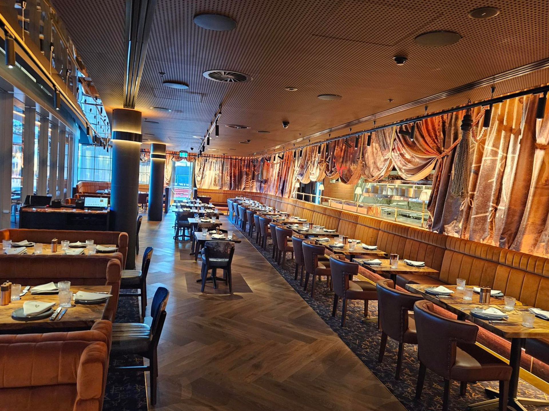 Interior of a Dimly Lit Restaurant With Tables, Booths, and Long, Ornate Curtains — Perth Electrical & Data in Joondalup, WA