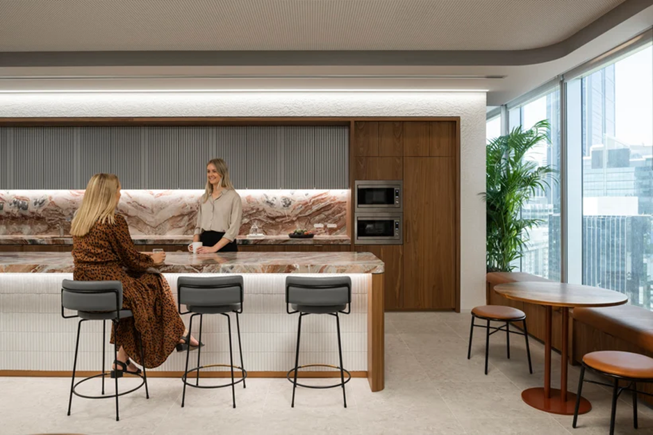 Two Women Chat at a Modern Office Kitchen Island — Perth Electrical & Data in Joondalup, WA