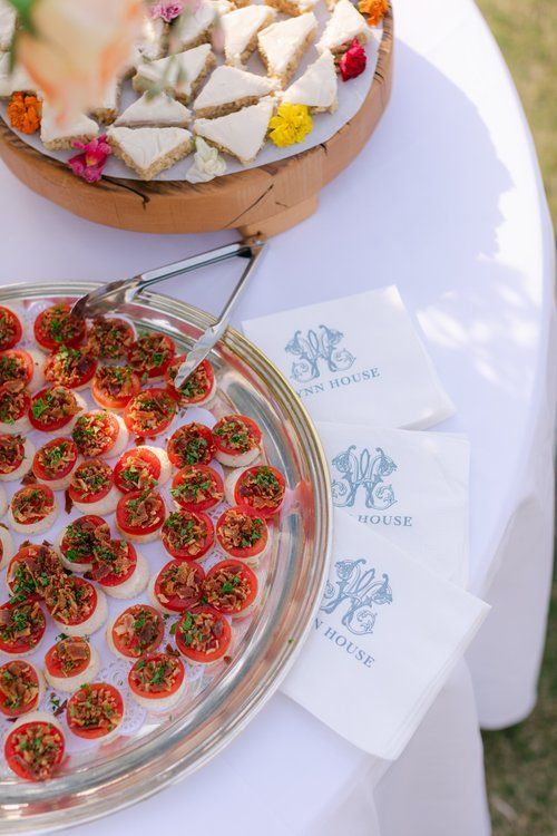 A silver tray filled with tomatoes and eggs on a table.