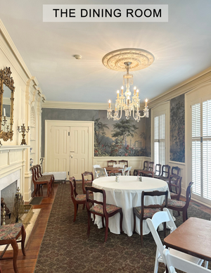 A dining room with tables and chairs and a chandelier