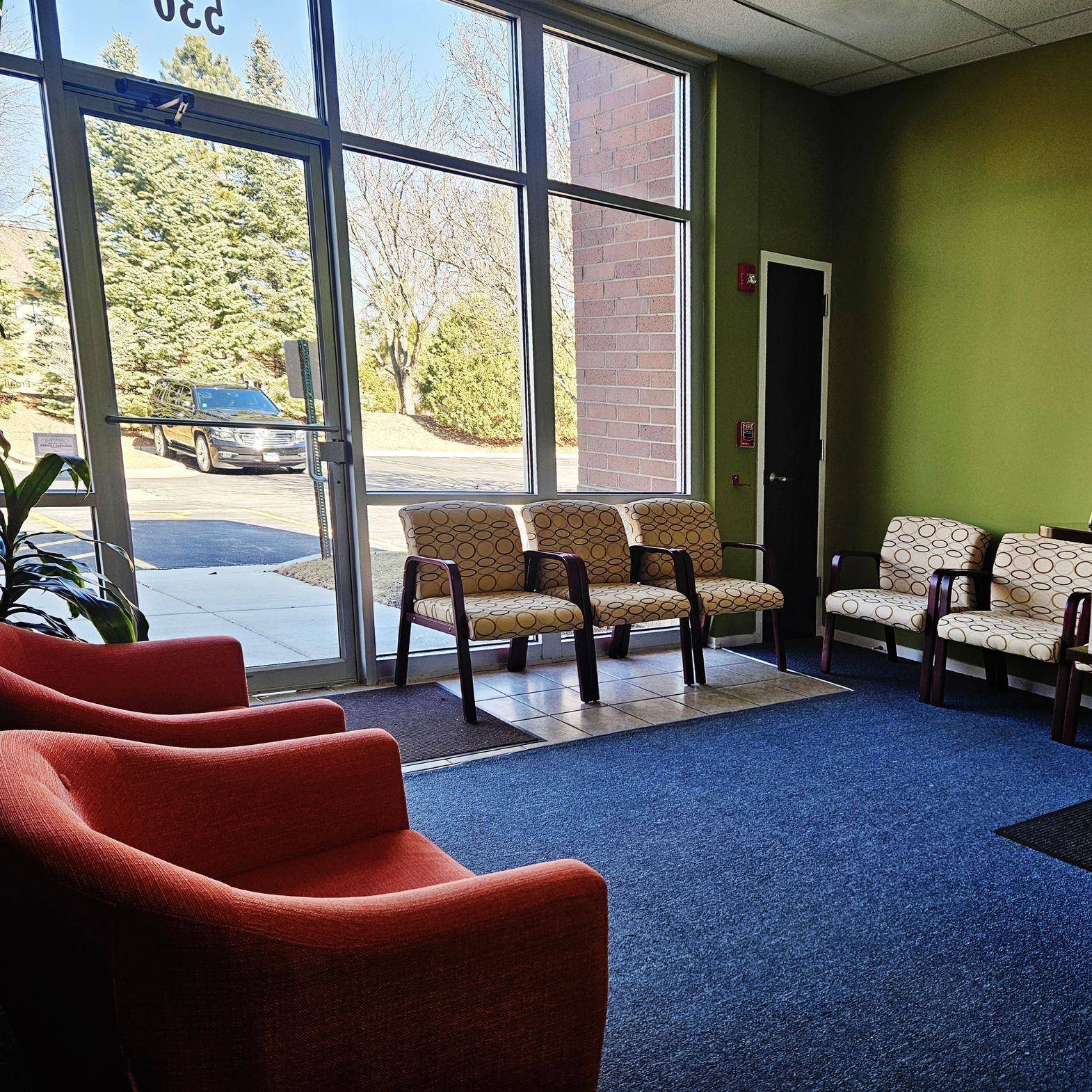 A waiting room with chairs and a large window