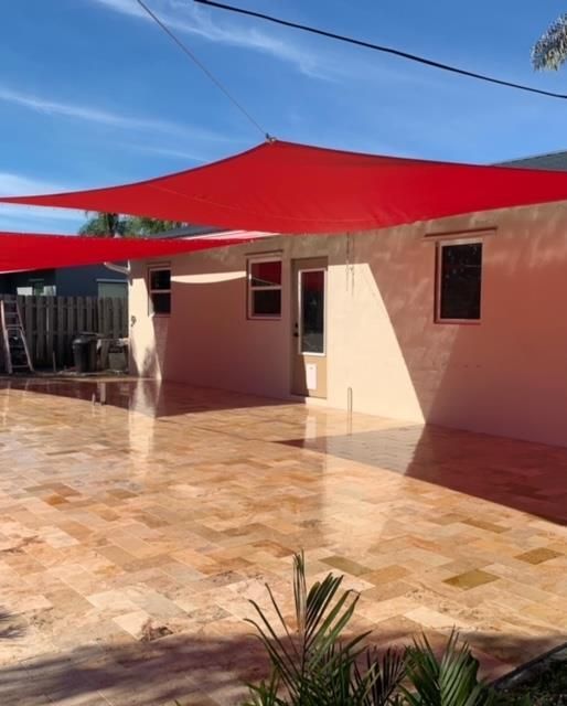 A house with a red umbrella in front of it