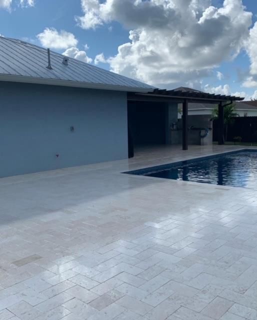 A house with a swimming pool in front of it