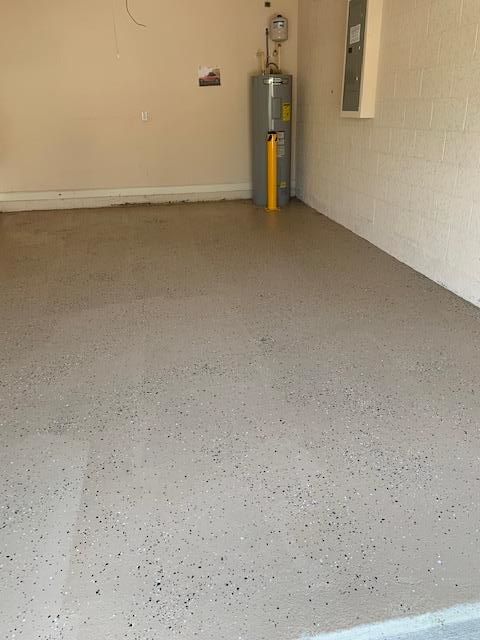 There is a water heater in the corner of the garage.