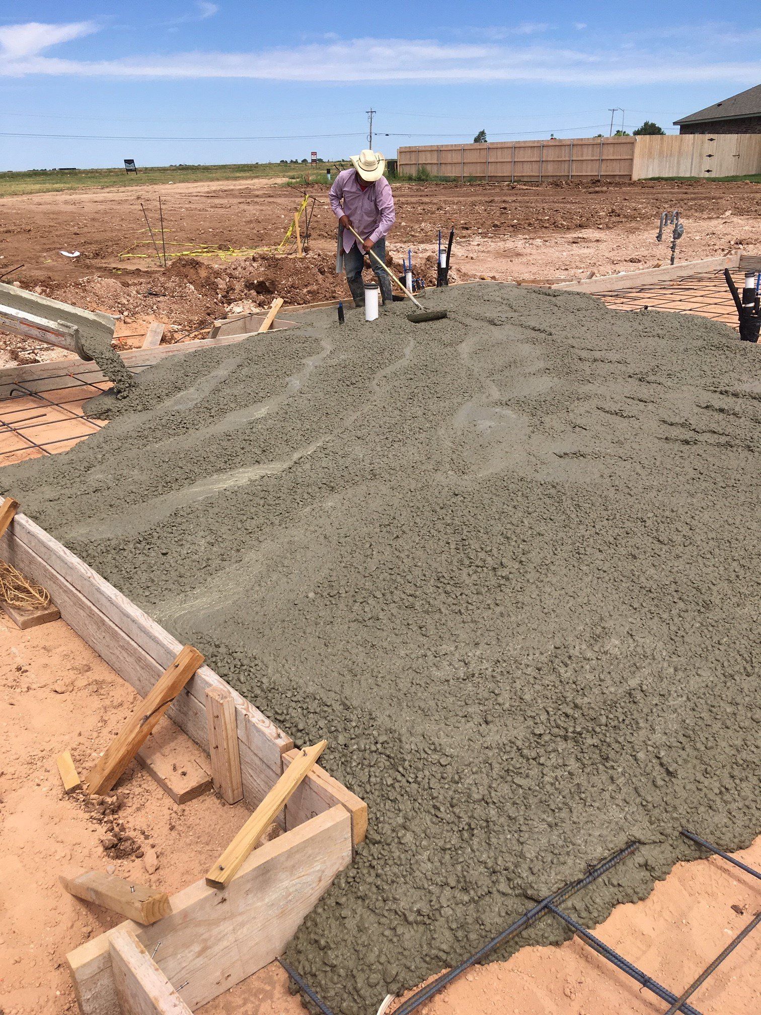 Man Flattening Concrete — Amarillo, TX — Thomas RediMix Co Inc
