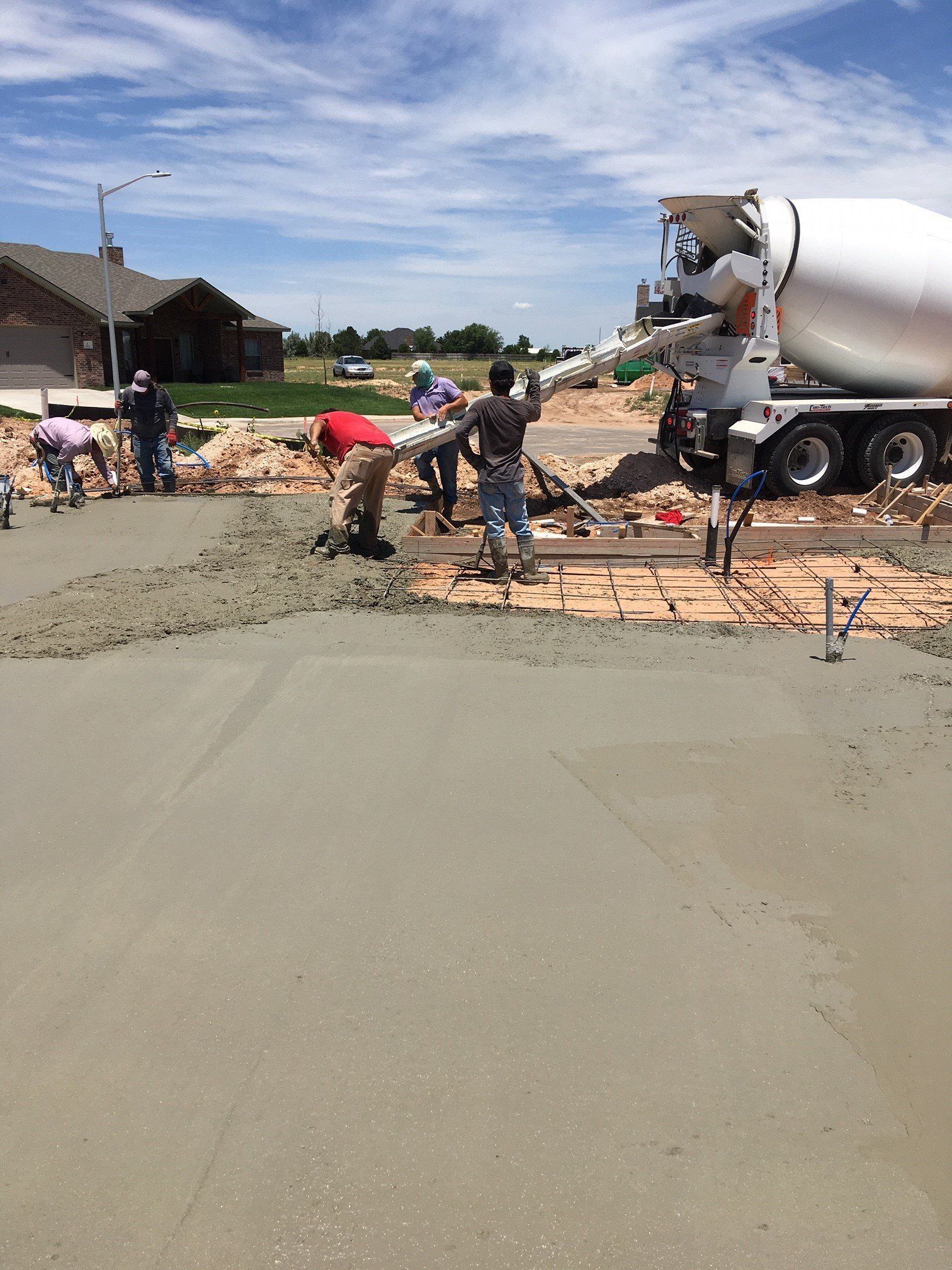Men Pouring Concrete From Truck — Amarillo, TX — Thomas RediMix Co Inc