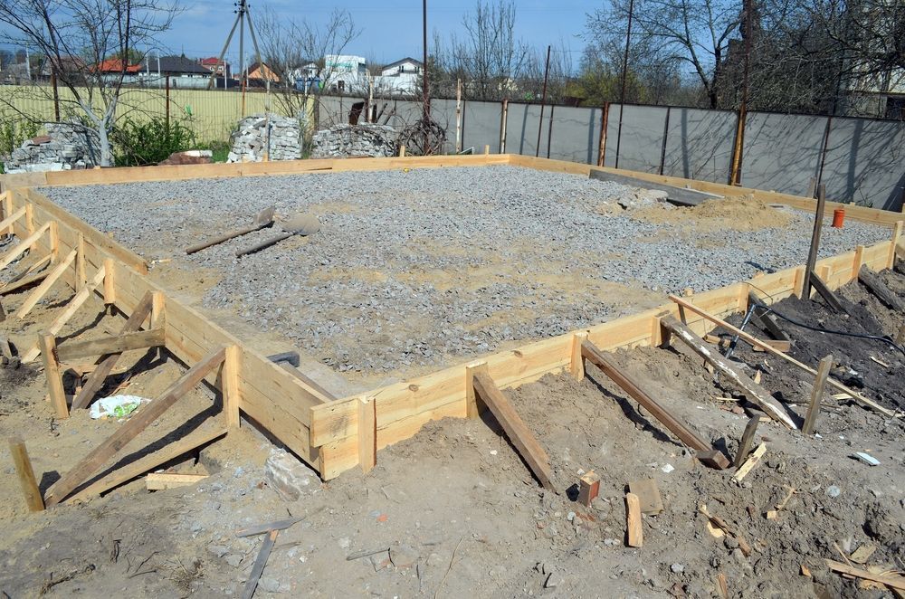 A wooden frame is sitting on top of a pile of gravel.