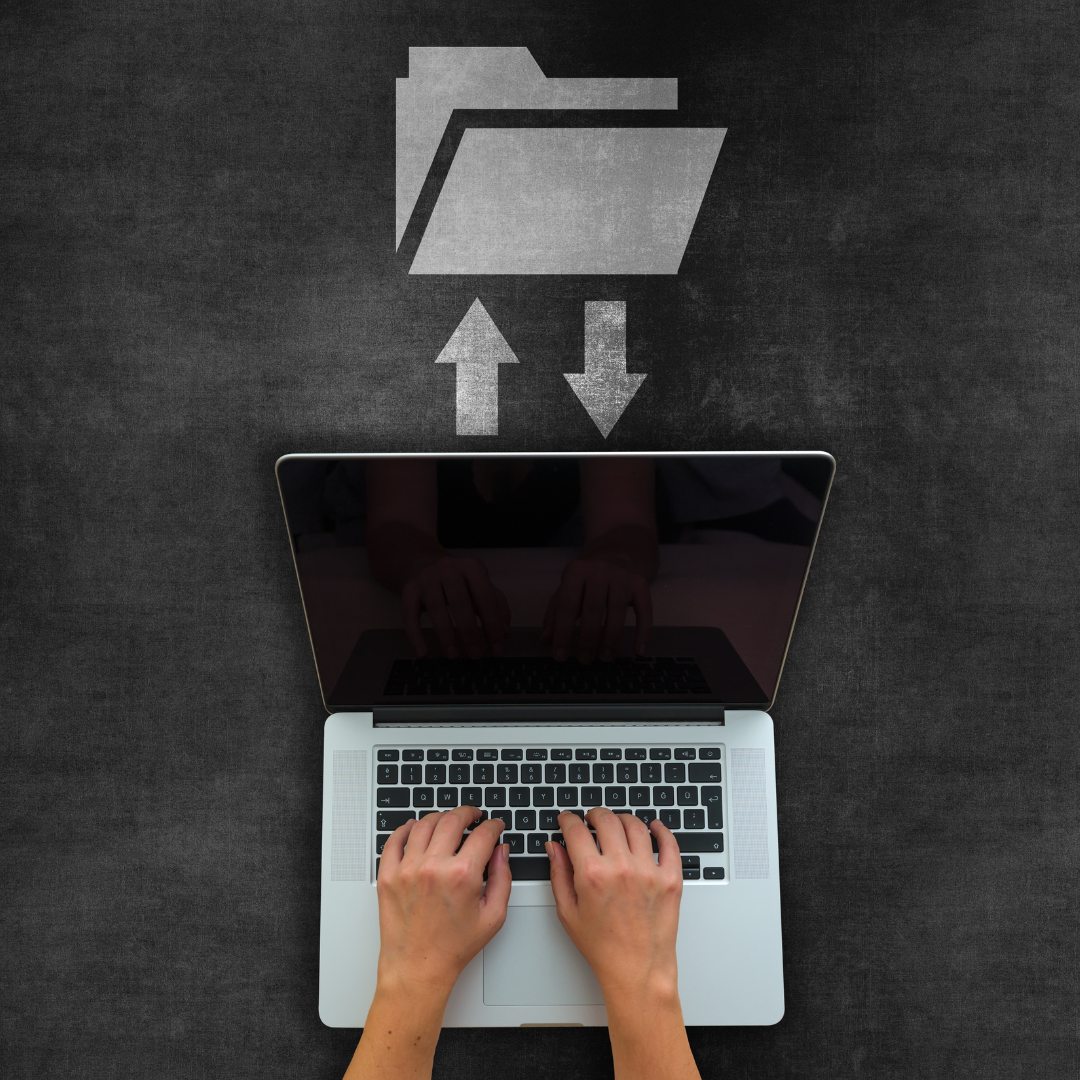 Laptop with hands typing, arrows pointing to/from a folder icon above.