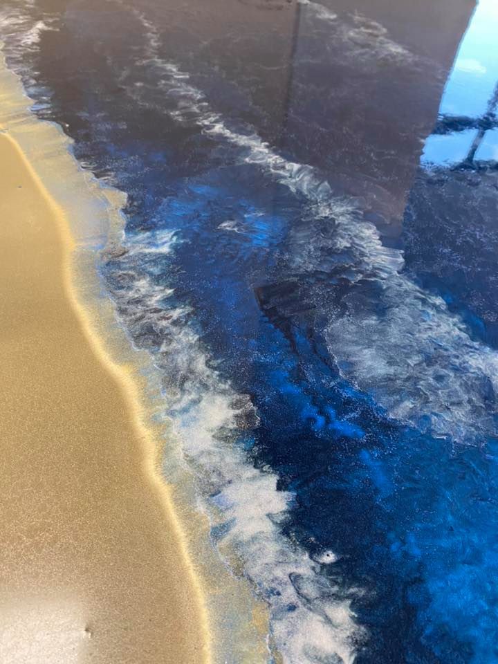 Beach scene: epoxy resin art with tan sand, foamy white waves, and deep blue ocean.