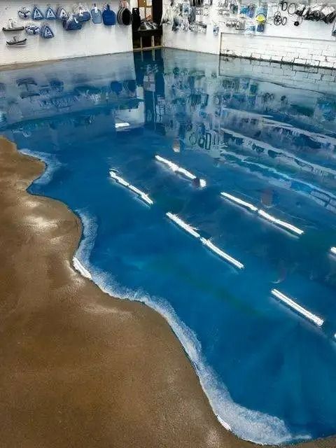 Ocean-themed epoxy floor in a room. The floor resembles a blue ocean with a brown