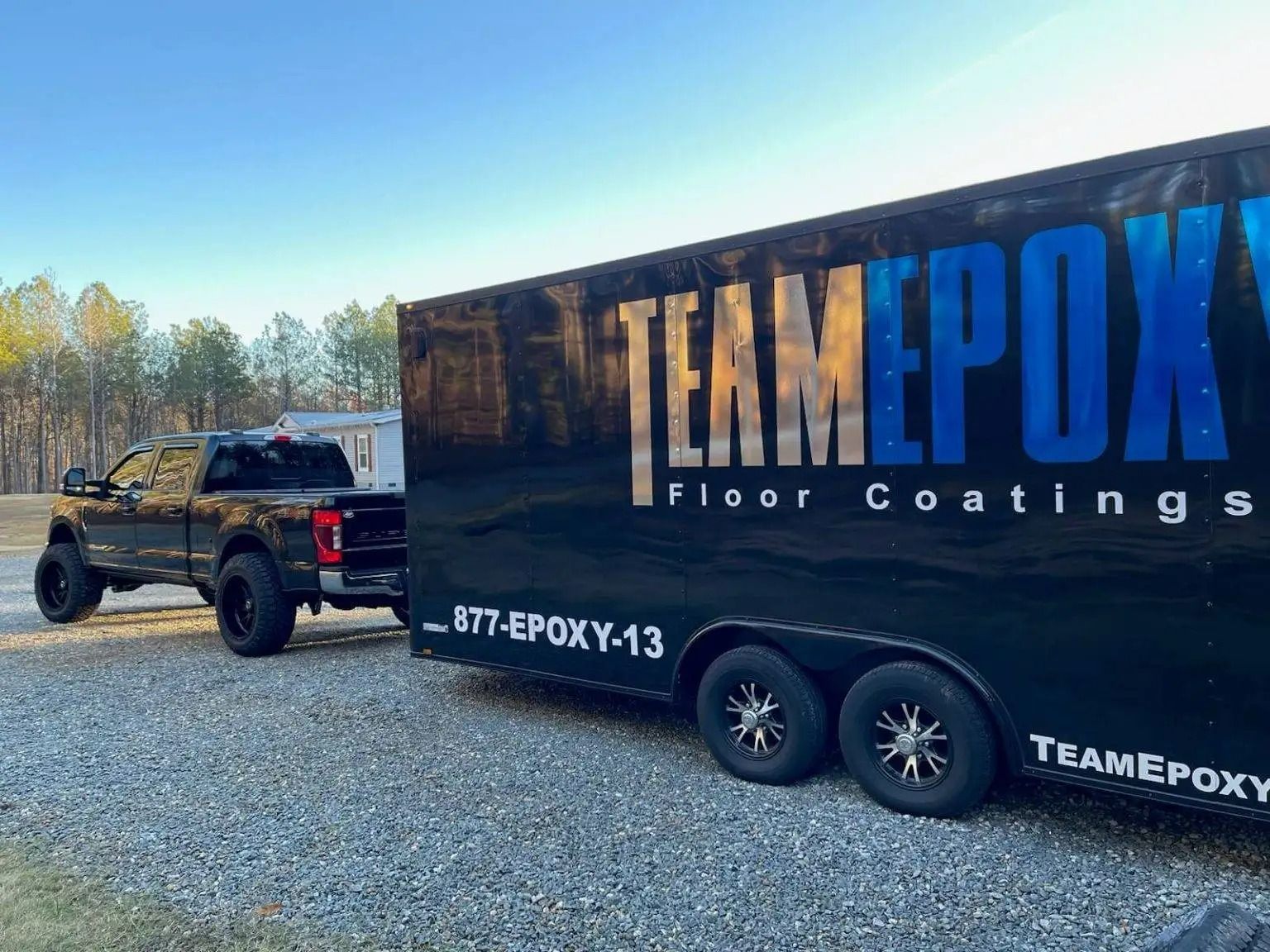 Black truck towing a trailer for