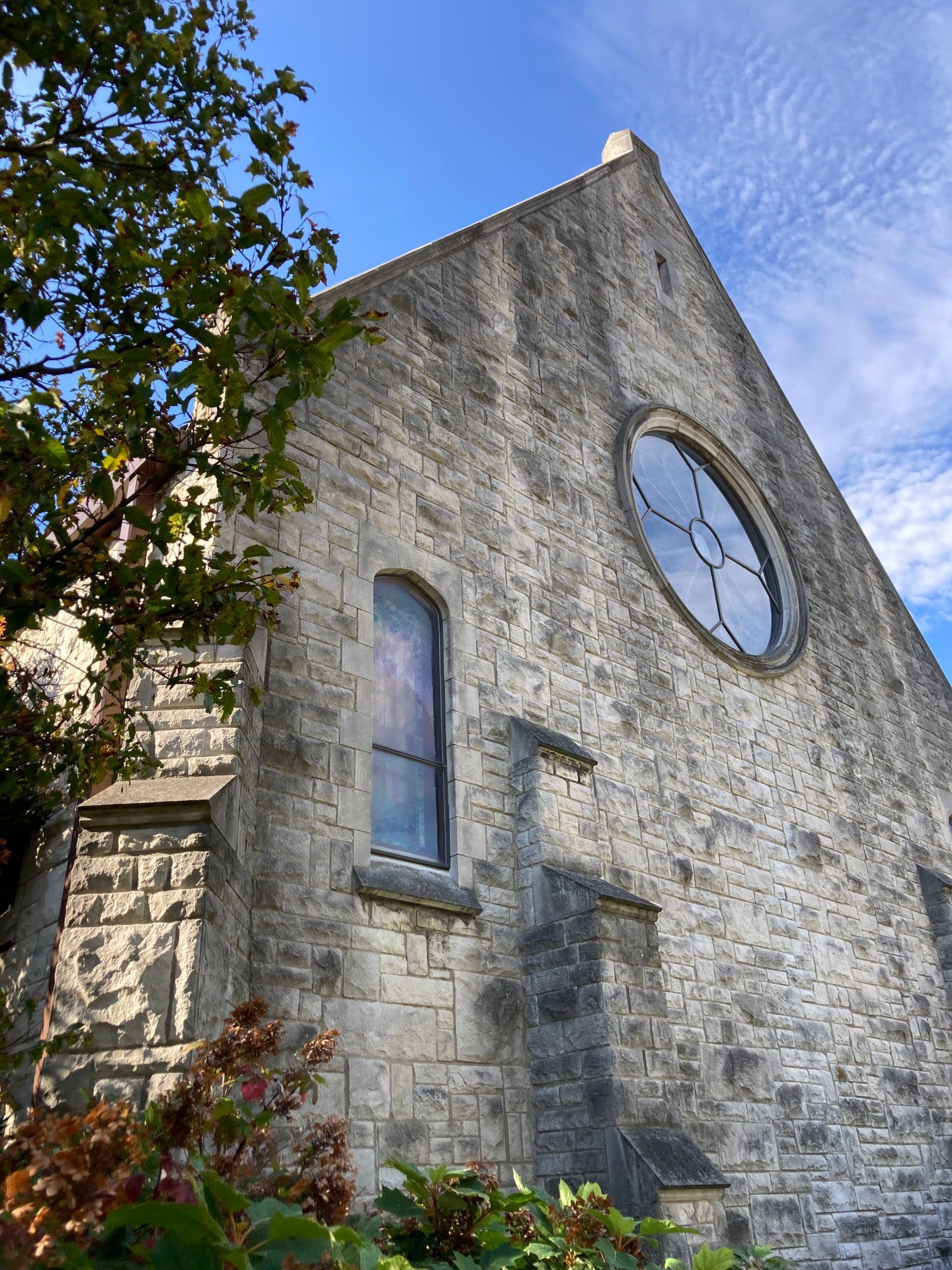 Large stone building aka the church with blue skies behind it