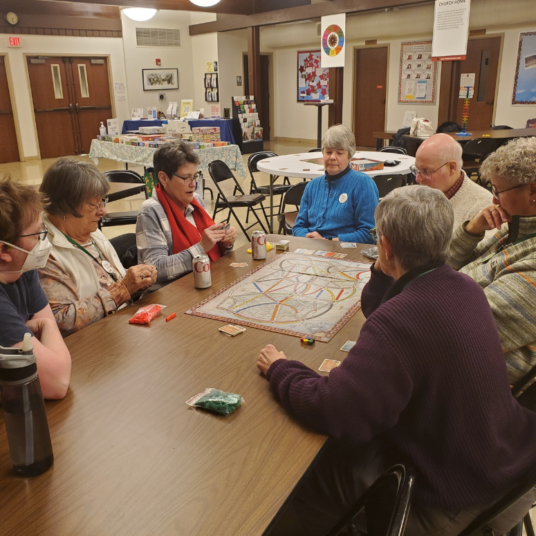 Congregants playing a board game during game night in Fellowship hall.