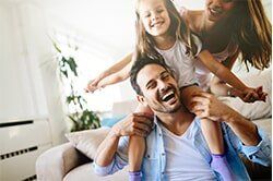 A Happy Family in a Living Room — Insurance Provider in St. Louis, MO