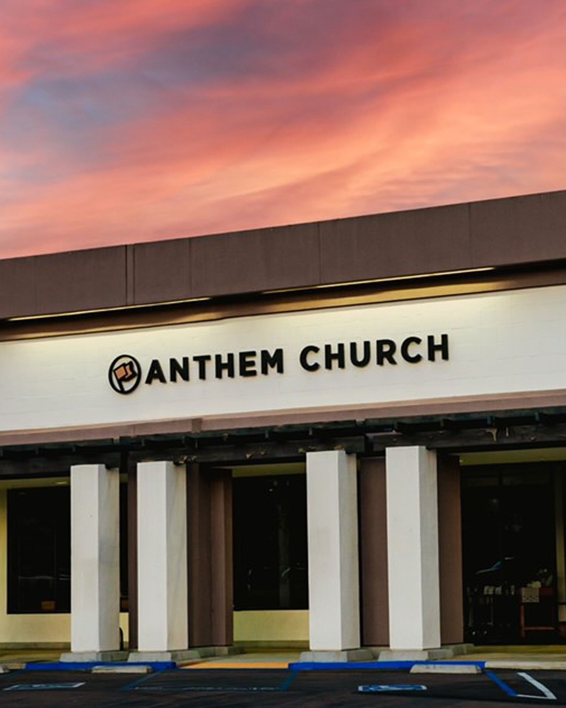 An anthem church building with a sunset in the background