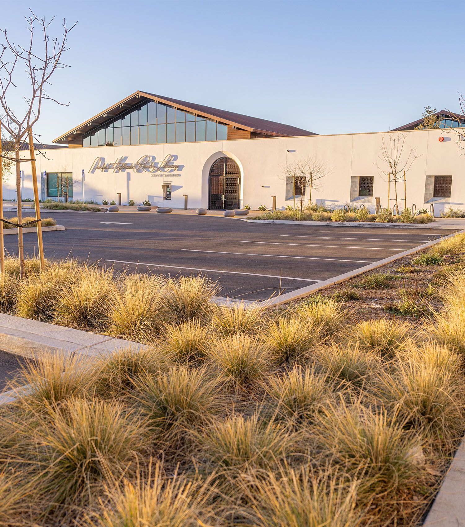 A large white building with a parking lot in front of it.