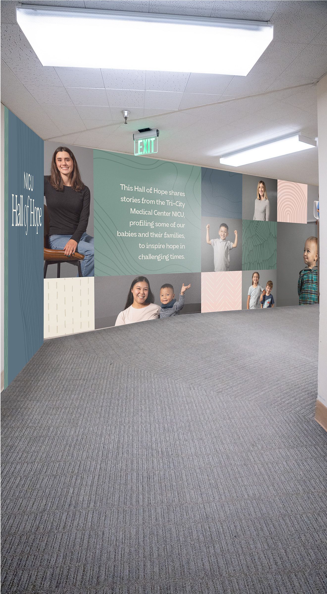 Hallway with photos of people on the walls, mostly children. Neutral colors, carpeted floor.
