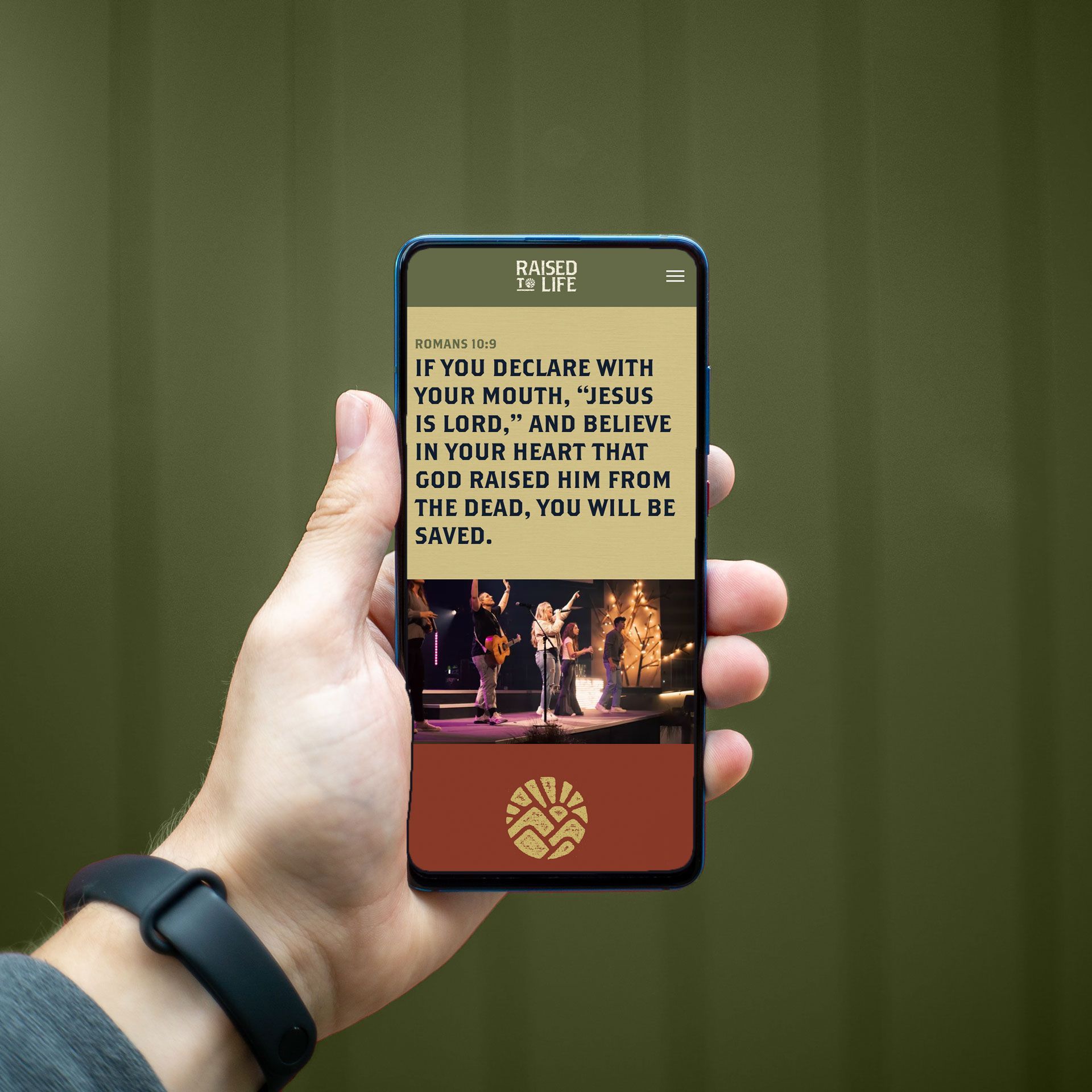 A person is holding a cell phone with a bible verse on it