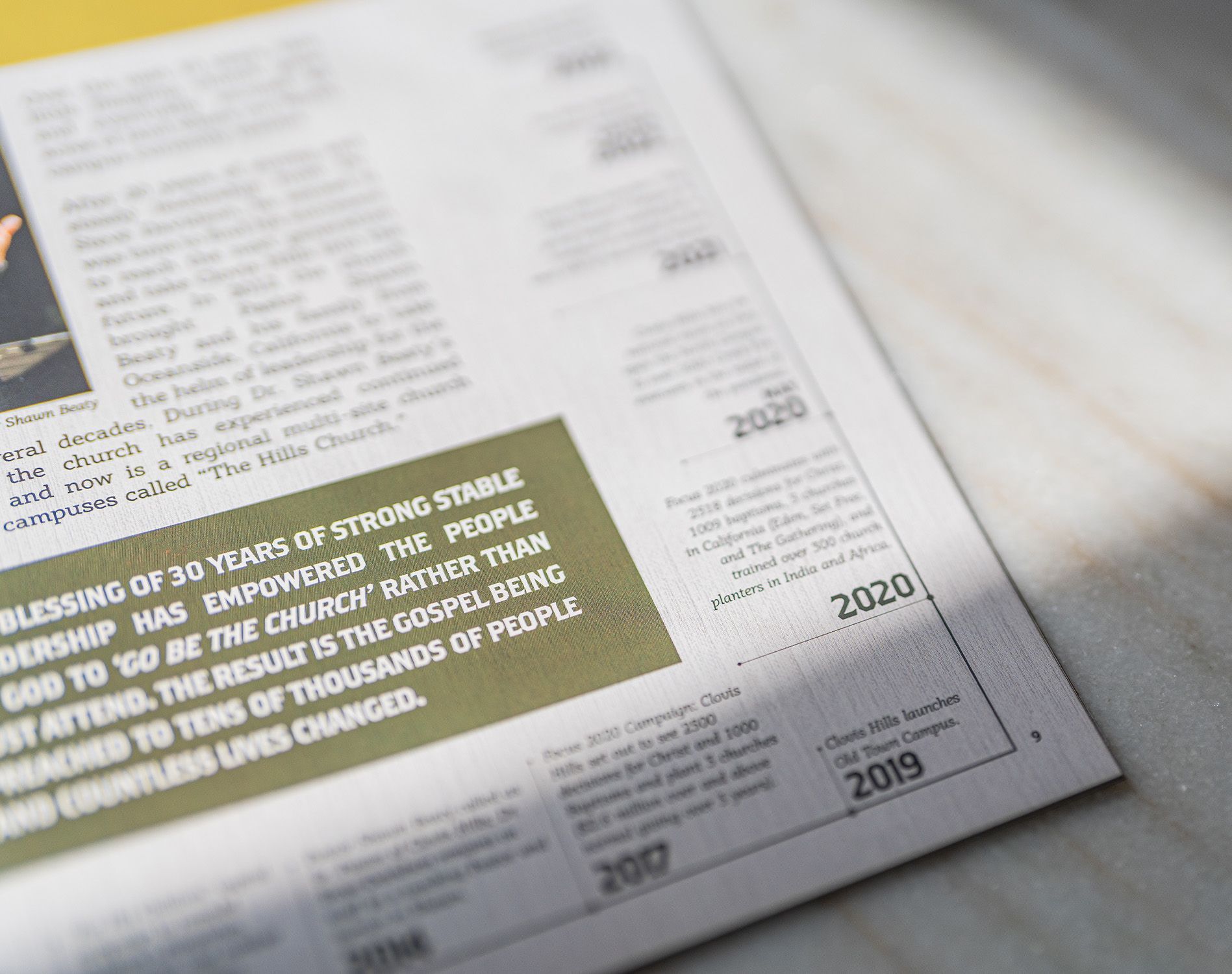 A close up of a newspaper with a picture of a man on it.