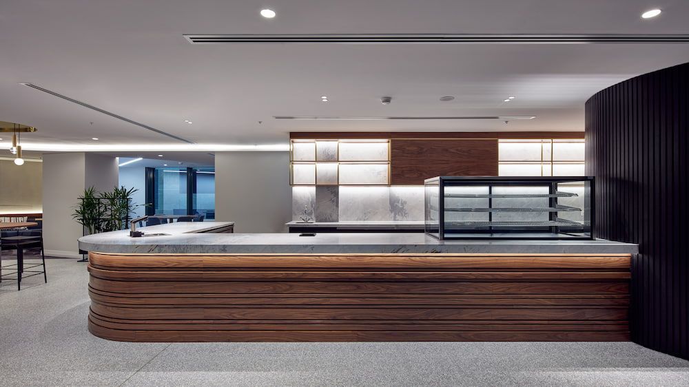 There is a Large Wooden Counter in the Middle of the Room — Concept Kitchens In Port Macquarie, NSW