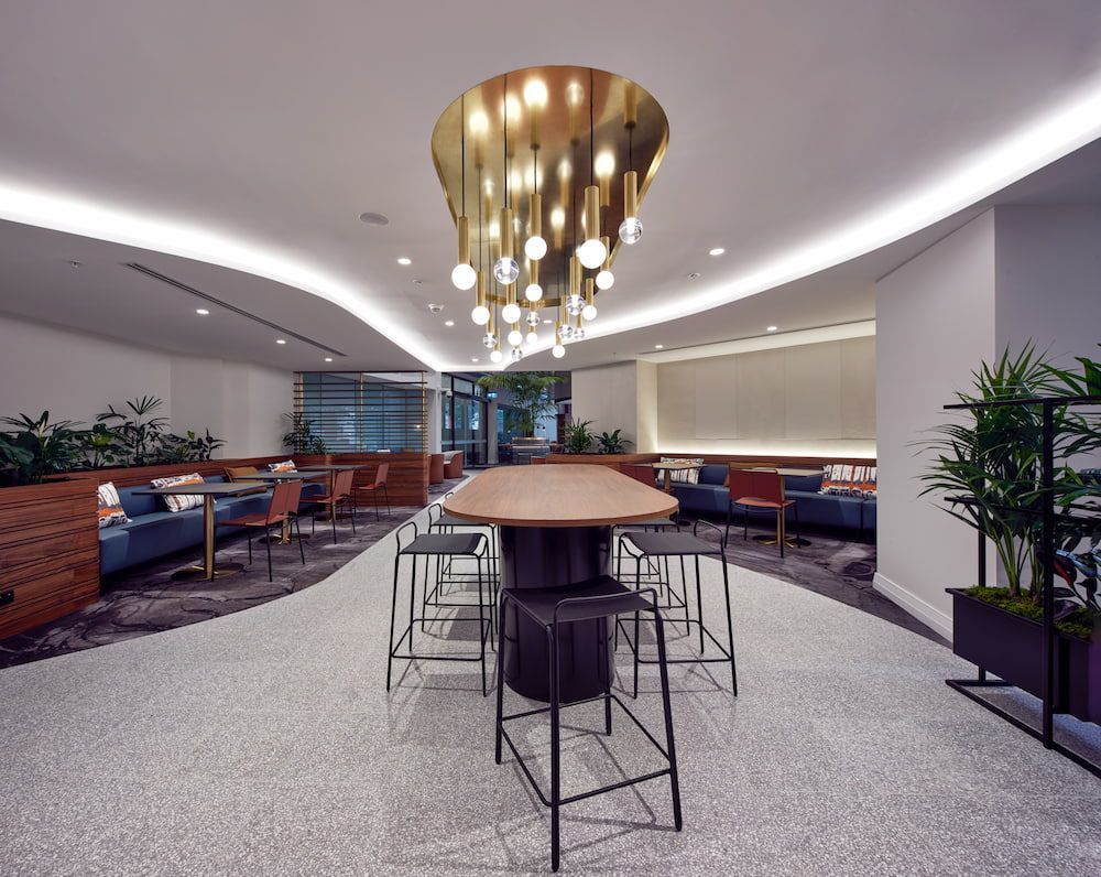 A Large Room With a Table and Chairs and a Chandelier Hanging From the Ceiling — Concept Kitchens In Port Macquarie, NSW